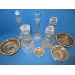 A quantity of lead crystal decanters and bottle coasters. Register and bid at ht