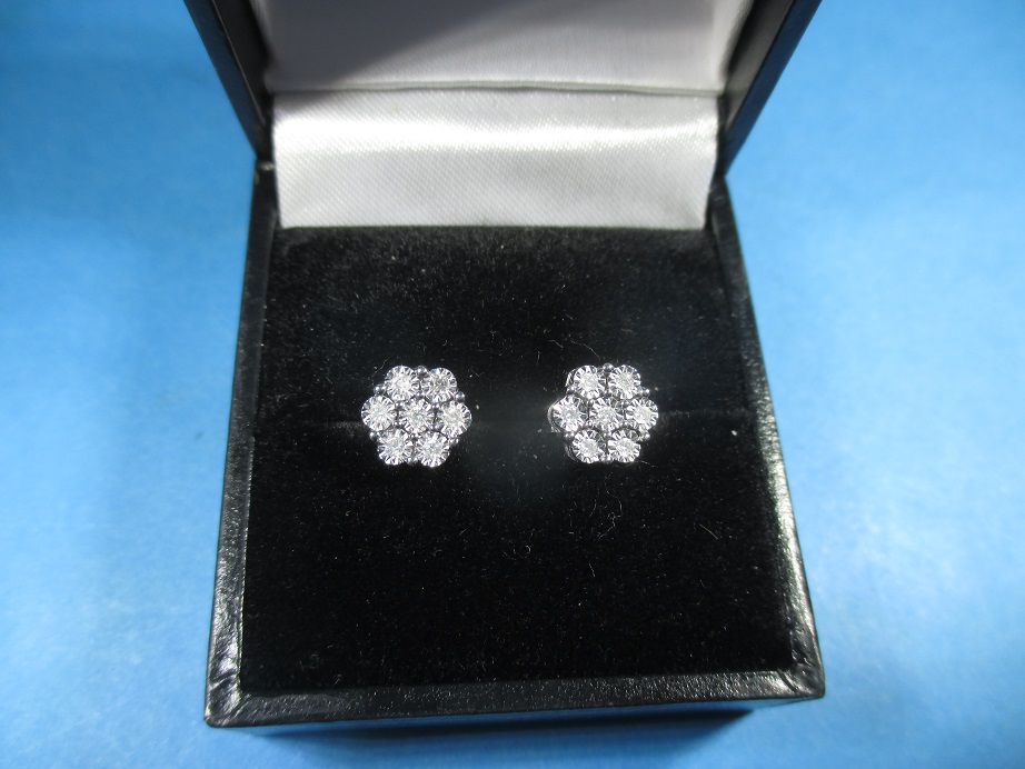 A pair of 9ct white gold and diamond daisy earrings