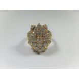 An 18ct yellow gold diamond cluster ring, approx ring size M