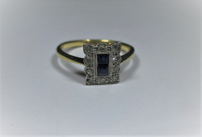 An 18ct gold and platinum Art Deco ring with 2 central square cut sapphires surr