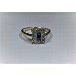 An 18ct gold and platinum Art Deco ring with 2 central square cut sapphires surr