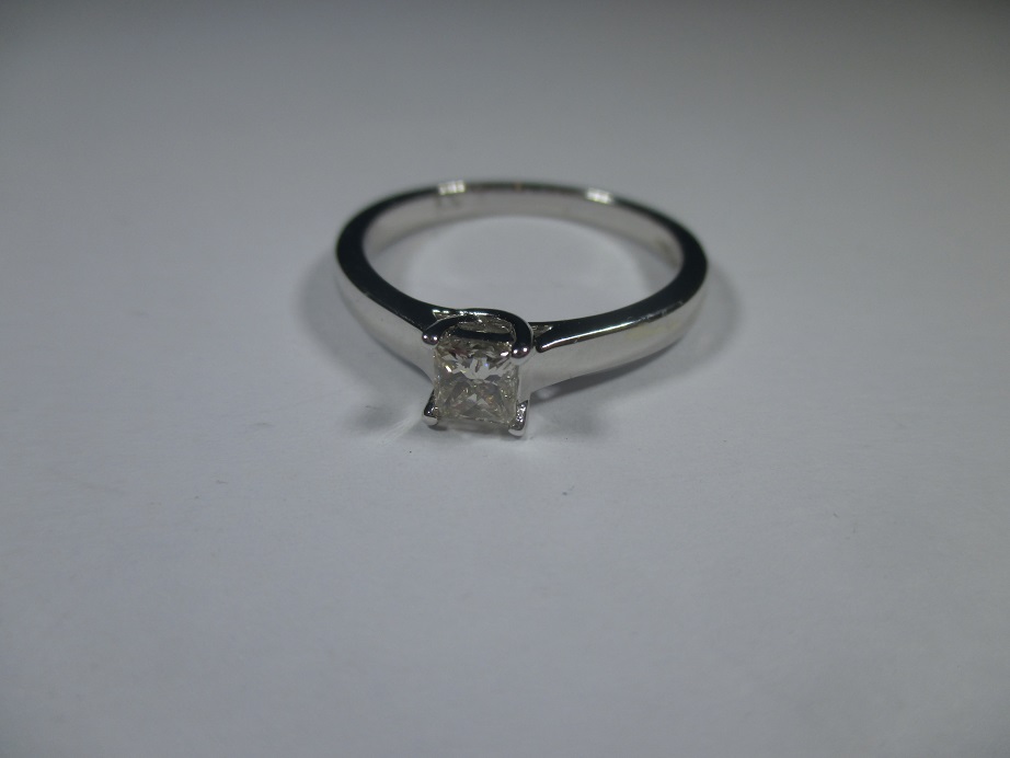 A 9ct white gold square cut diamond solitaire ring, approx ring size N