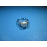 A white gold and pearl ring marked 10k