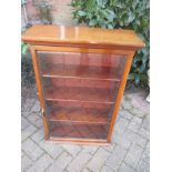 A small 19th century glazed door, wall mounted bookcase