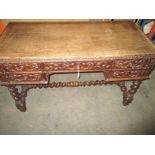 A mid 19th century carved oak desk