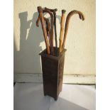 A vintage stick stand and a quantity of sticks