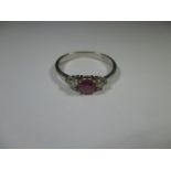 An 18ct white gold Diamond and ruby ring, approx ring size N1/2