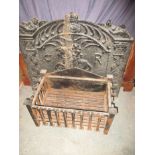 A large cast iron fire back and a fire basket