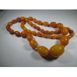 A vintage butterscotch amber necklace, approx weight 67g