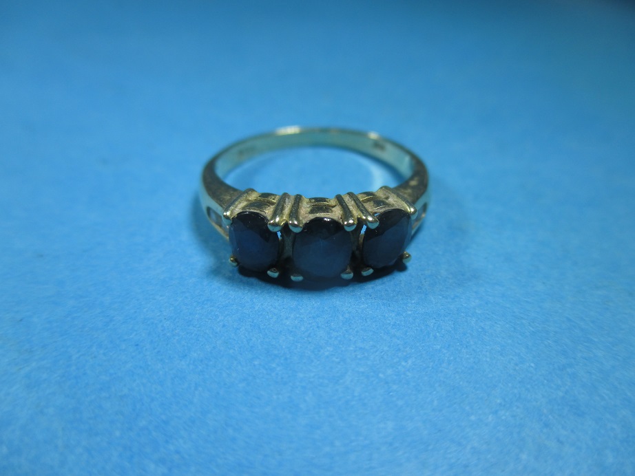 A 9ct gold 3 stone sapphire ring with diamond chips to each shoulder, approx rin