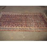 An antique hand woven Persian wool rug, approx size 4ft6" x 9ft6"