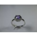 An 18ct white gold amethyst and diamond Halo ring, approx finger size N