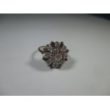 A 9ct gold diamond and ruby cluster ring, approx. ring size J