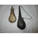 Two antique powder flasks one made of camel leather