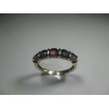 A 9ct gold ring set with various coloured stones