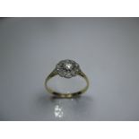 An unmarked yellow gold diamond daisy cluster ring, approx finger size N