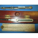 A 19th century Stanley proportional divider in original wood case, a pair of compasses and a