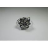An 18ct white gold diamond and sapphire cluster ring, approx. ring size P