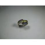 A 9ct gold ring set with 3 rows of multi-coloured stones