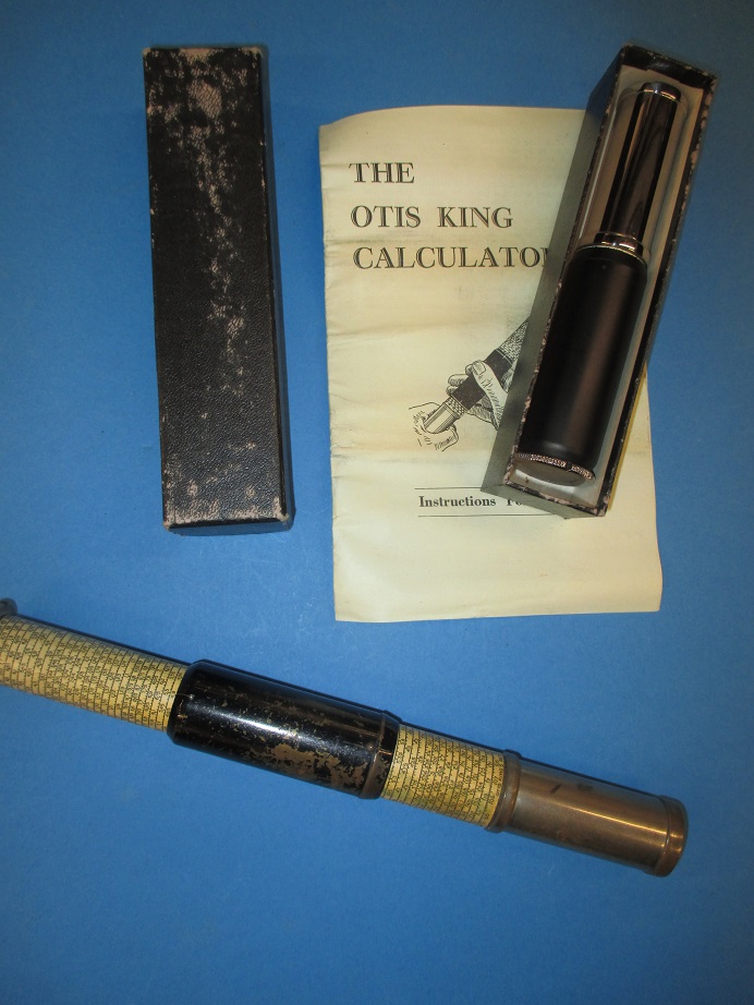 A vintage Otis King's pocket calculator and a later version in box