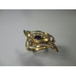A stylised yellow metal ring marked 21k, approx finger size R