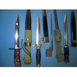 Four vintage dagger bayonets in scabbards