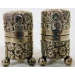 A decorative small pair of Chester silver pepper p