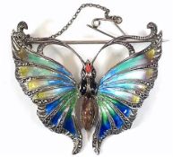 A white metal enamelled butterfly brooch, instinct