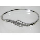 An 18ct white gold bangle set with approx. 1ct dia