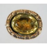 A 19thC. yellow metal closed back brooch with citr