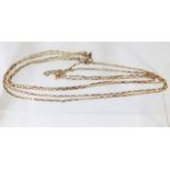 A 9ct gold yellow metal long guard chain 73in long