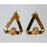 A pair of 18ct gold earrings set with diamonds & g