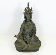 A Tibetan bronze Buddha with right hand holding va