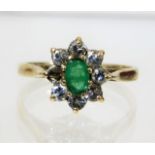 A 9ct gold ring set with emerald & diamond, lackin