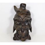 A carved lightwood Oriental mask 13.75in