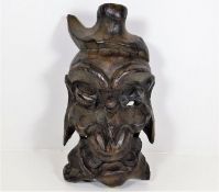 A carved lightwood Oriental mask 13.75in