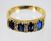 A yellow metal ring, tests as 18ct, set with sapphire & diamonds 4.2g size S