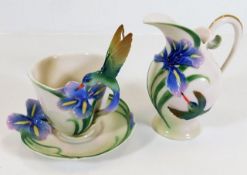 A Franz porcelain hummingbird cup & saucer twinned