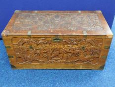 A Chinese carved camphor wood chest with brass fit