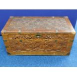 A Chinese carved camphor wood chest with brass fit