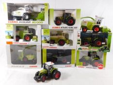 Eight boxed Claas tractor models including by Nors