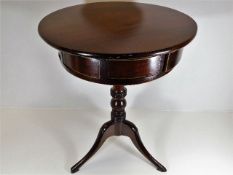 A 19thC. mahogany drum top table with six drawers