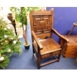 An antique Jacobean style oak chair with two drawe