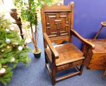 An antique Jacobean style oak chair with two drawe