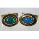 A pair of gents 9ct gold cufflinks set with black