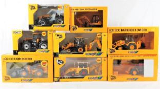 Eight boxed diecast JCB heavy machinery vehicles