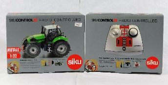 A boxed Siku radio controlled tractor with control