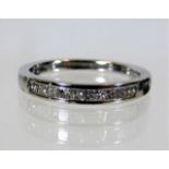 An 18ct white gold ring half eternity ring set wit