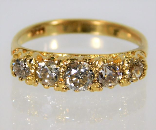 An 18ct gold diamond ring set with five stones of