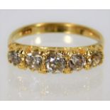 An 18ct gold diamond ring set with five stones of